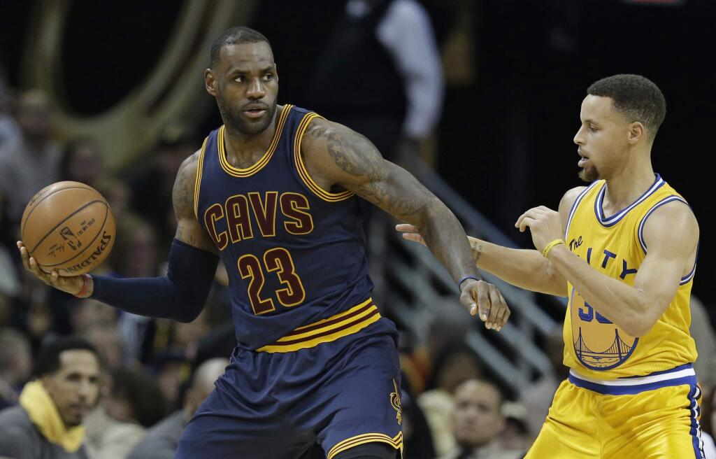The Cleveland Cavaliers' LeBron James, left, drives past Golden State Warriors' Stephen Curry in the second half Monday, Jan. 18, 2016, in Cleveland. The Warriors won 132-98. (AP Photo/Tony Dejak)
