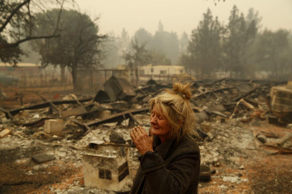 Cathy Fallon reacts as she stands near the charred remains of her home Friday, Nov. 9, 2018, in Paradise, Calif. 'I'll be darned if I'm going to let those horses burn in the fire' said Fallon, who stayed on her property to protect her 14 horses, 'It has to be true love.' All 14 of the horses survived. (AP Photo/John Locher)