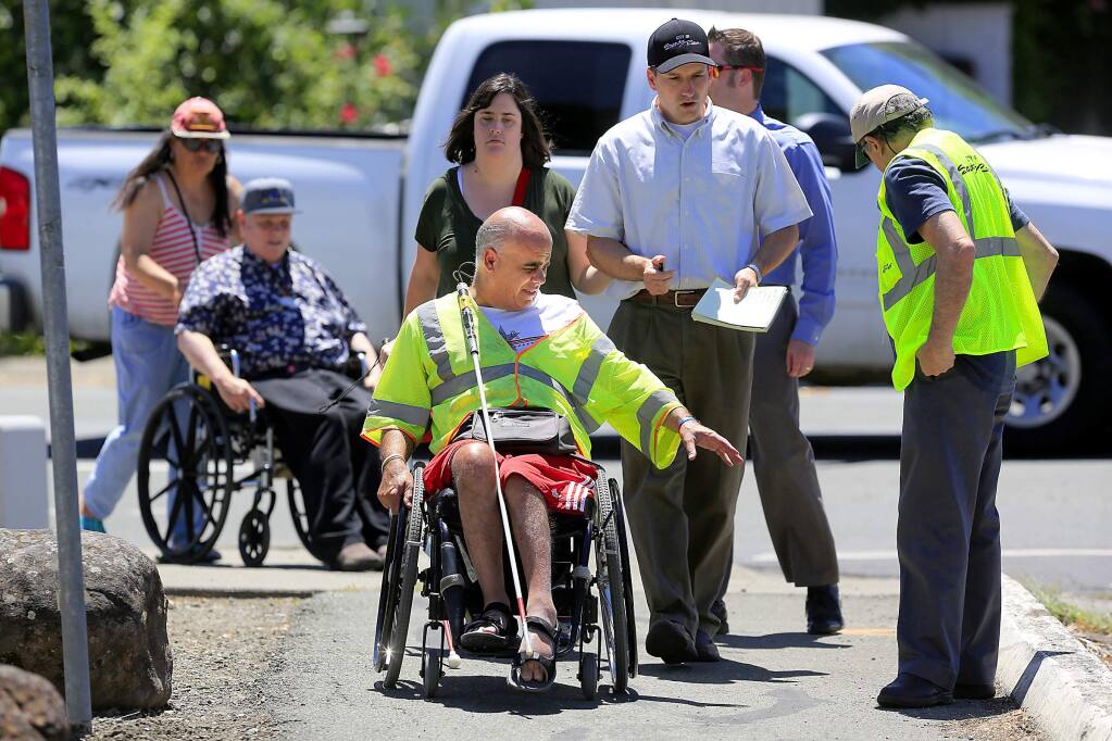 Ken Rossi, a blind disabled advocate, leads a group of disabled people and City of Santa Rosa traffic engineers on a 'walkabout' to identify difficult sidewalks and pathways near his home. (JOHN BURGESS/The Press Democrat)
