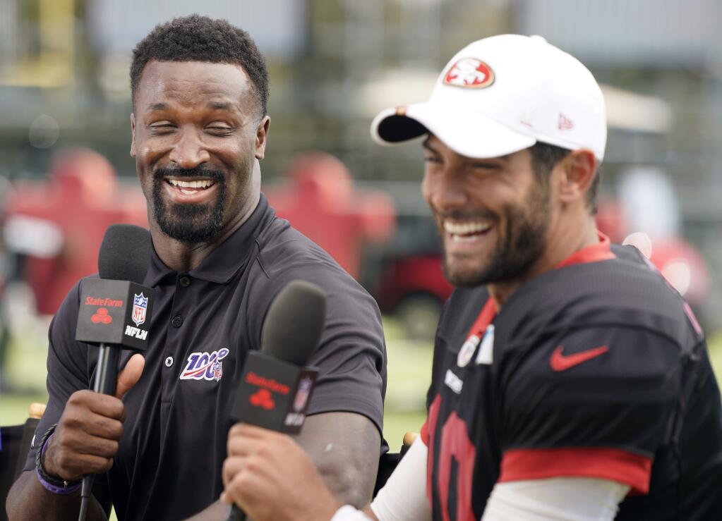 James Jones, analyst on the NFL Network, laughs during an interview with San Francisco 49ers quarterback Jimmy Garoppolo at the 49ers football team's training camp in Santa Clara, Calif., Saturday, Aug. 3, 2019. (AP Photo/Tony Avelar)