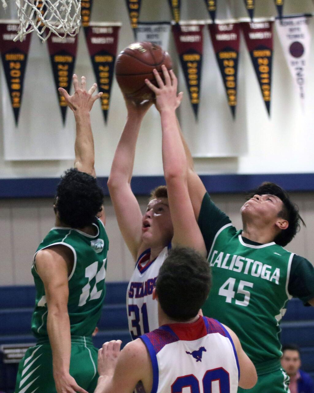 DWIGHT SUGIOKA/FOR THE ARGUS-COURIERTyler Pease goes up for a St. Vincent basket over a pair of Calistoga defenders in the Mustangs' 42-25 victory.