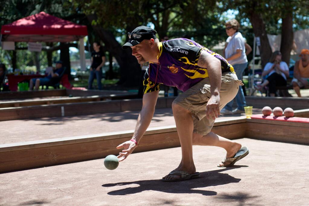 Rich Gravelle throws a bocce ball down the court during Bocce for a Cure, a bocce tournament benefiting the American Diabetes Association at Julliard Park in Santa Rosa, California, on July 12, 2014. (Alvin Jornada / For The Press Democrat)