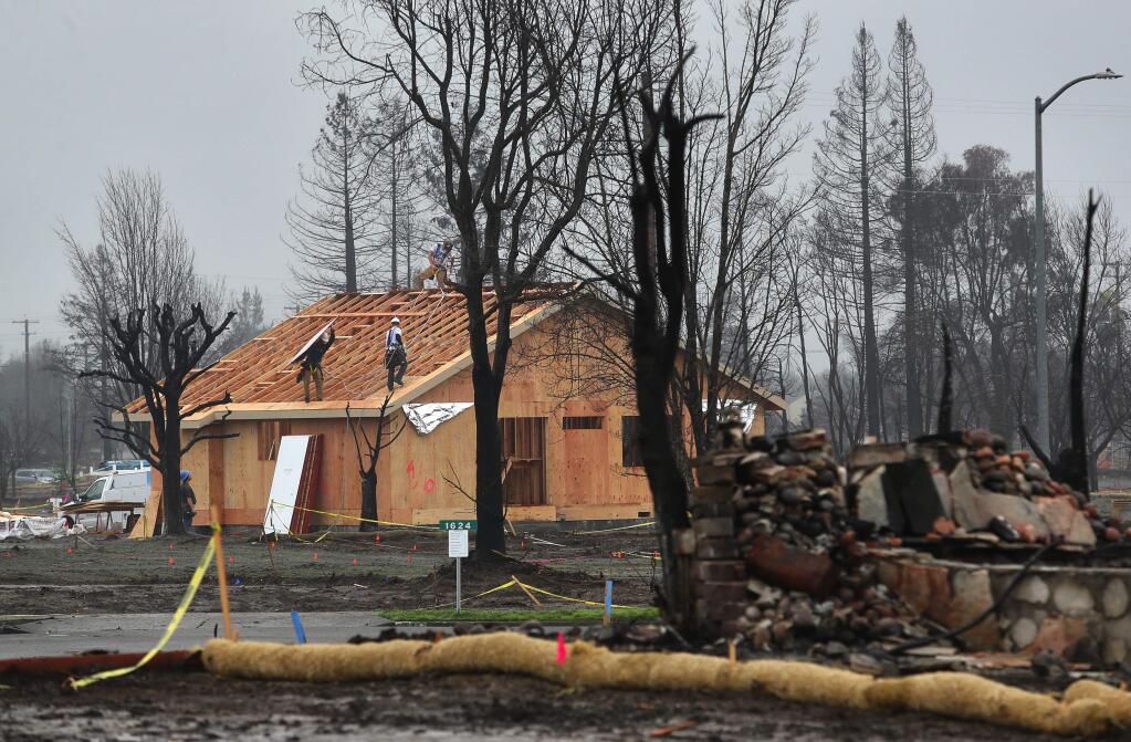 Construction continues on a new home being built after the wildfire that swept through Coffey Park. (CHRISTOPHER CHUNG / The Press Democrat)