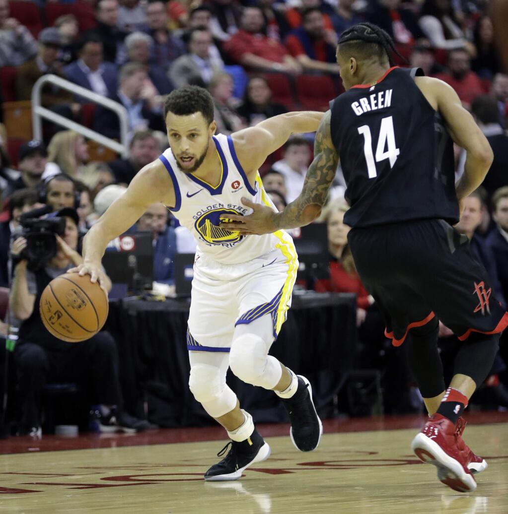 The Golden State Warriors' Stephen Curry, left, drives toward the basket as the Houston Rockets' Gerald Green defends during the first half Thursday, Jan. 4, 2018, in Houston. (AP Photo/David J. Phillip)