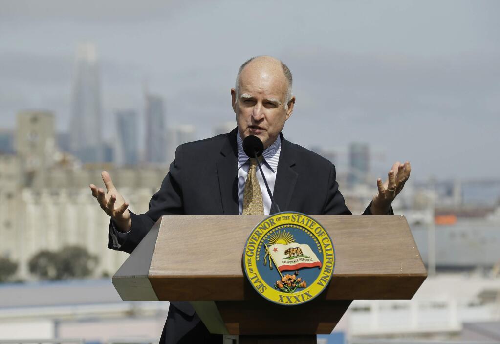 FILE - In this Sept. 29, 2017 file photo, California Gov. Jerry Brown gestures while speaking in San Francisco. California women will have more tools to fight pay discrimination, more resources to buy diapers and pay for childcare and more opportunities for parental leave under bills signed by Brown. (AP Photo/Eric Risberg, file)