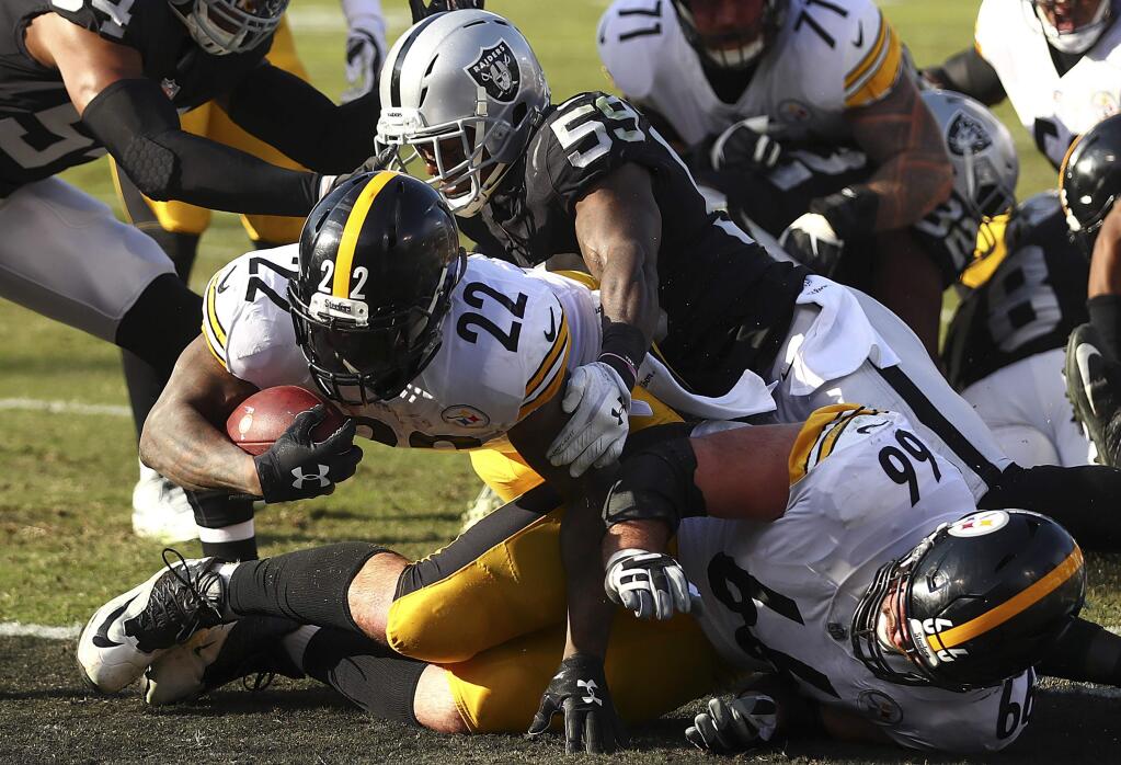Pittsburgh Steelers running back Stevan Ridley (22) scores against the Oakland Raiders during the first half of an NFL football game in Oakland, Calif., Sunday, Dec. 9, 2018. (AP Photo/Ben Margot)