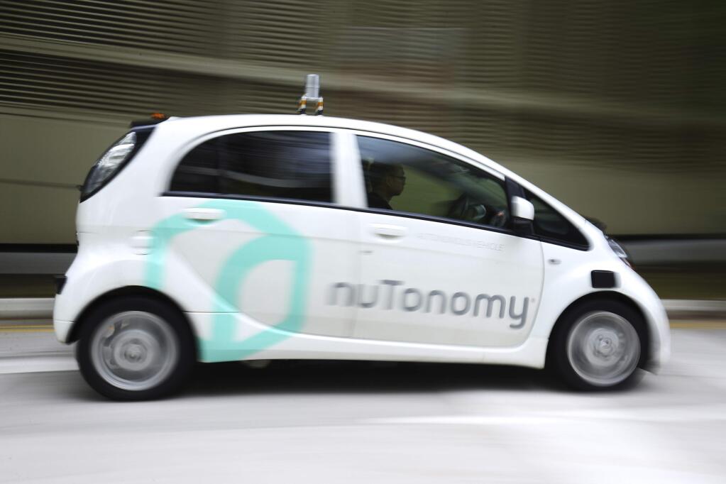 An autonomous vehicle is driven during its test drive in Singapore Wednesday, Aug. 24, 2016. The world's first self-driving taxis, operated by nuTonomy, an autonomous vehicle software startup, will be picking up passengers in Singapore starting Thursday, Aug. 25. The service will start small - six cars now, growing to a dozen by the end of the year. The ultimate goal, say nuTonomy officials, is to have a fully self-driving taxi fleet in Singapore by 2018, which will help sharply cut the number of cars on Singapore's congested roads. (AP Photo/Yong Teck Lim)