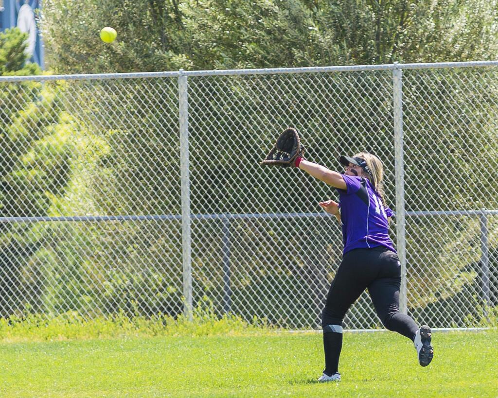 RICH LANGDON/FOR THE ARGUS-COURIERPetaluma's Cassie Baddeley makes a running catch in center field in T-Girls' 8-5 loss to highly rated Alhambra.