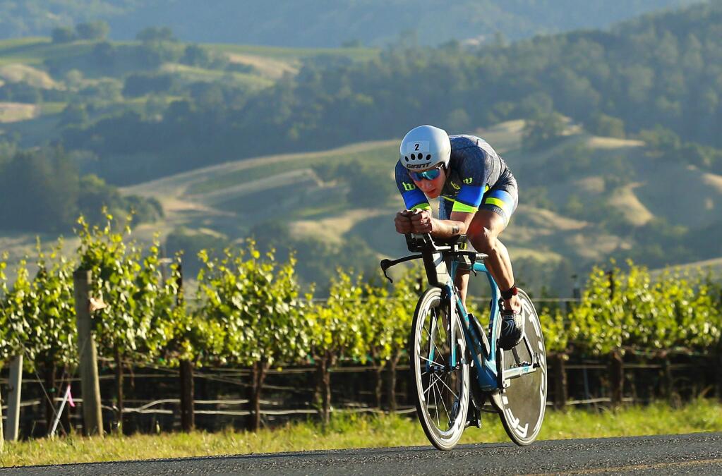 The early leader in the first Ironman Santa Rosa triathlon races through the Alexander Valley on Saturday morning. (John Burgess/The Press Democrat)