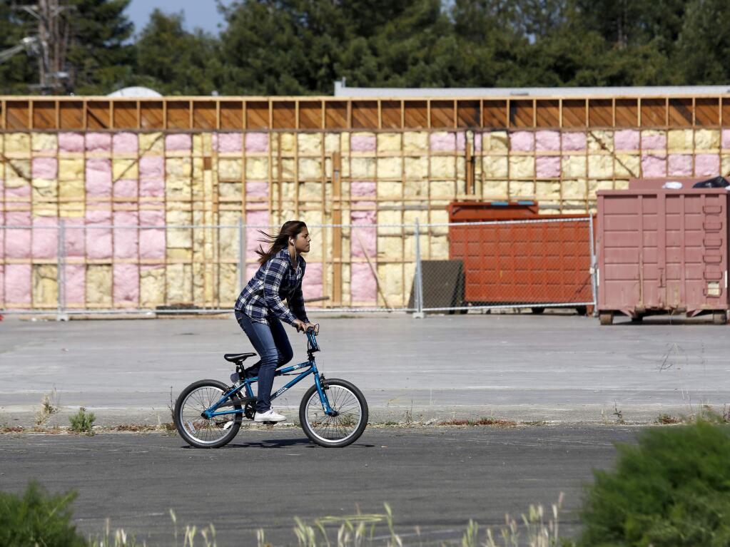 A girl rides her bicycle near the site of old Albertsons on Sebastopol Avenue on Sunday, June 14, 2015. (BETH SCHLANKER/ PD FILE)