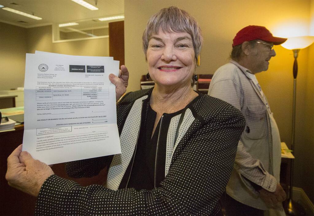 Dispensary proprietor Jewel Mathieson picks up a business license from City Hall, which allows Sonoma Patient Group to deliver medical cannabis products into the City of Sonoma, on Dec. 20, 2018. (Photo by Robbi Pengelly/Index-Tribune)