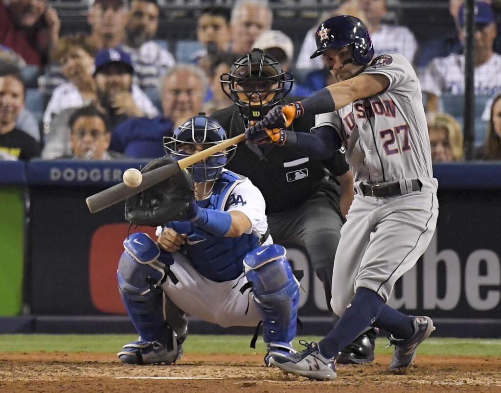 In this Oct. 25, 2017, file photo, the Houston Astros' Jose Altuve hits a home run against the Los Angeles Dodgers during the 10th inning of Game 2 of the World Series in Los Angeles. (AP Photo/Mark J. Terrill, File)