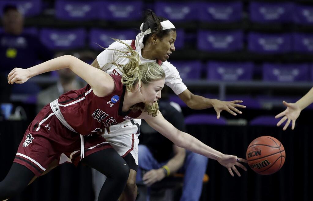 New Mexico State's Brooke Salas, front, and Stanford's Briana Roberson chase a loose ball during the second half of a first-round game in the NCAA tournament Saturday, March 18, 2017, in Manhattan, Kan. Stanford won 72-64. (AP Photo/Charlie Riedel)