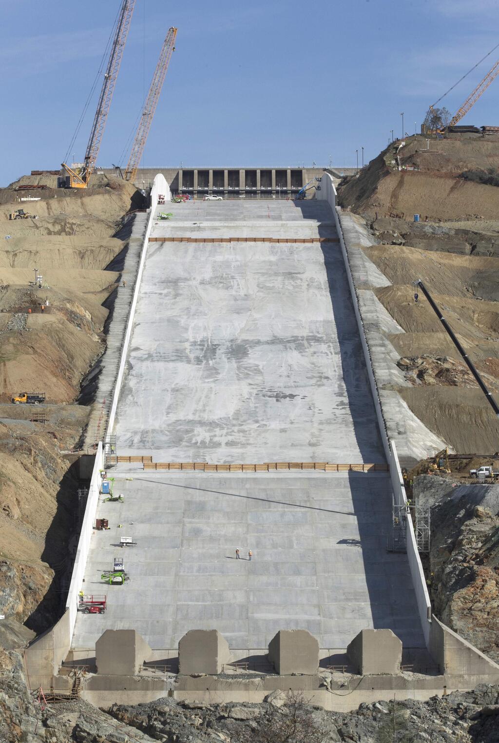 Work continues on the Oroville Dam spillway, Thursday, Nov. 30, 2017, in Oroville, Calif. California water officials and the construction manager said Thursday, that recently found hairline cracks on the spillway are normal and expected in reinforced concrete because it shrinks as it cures. (AP Photo/Rich Pedroncelli)
