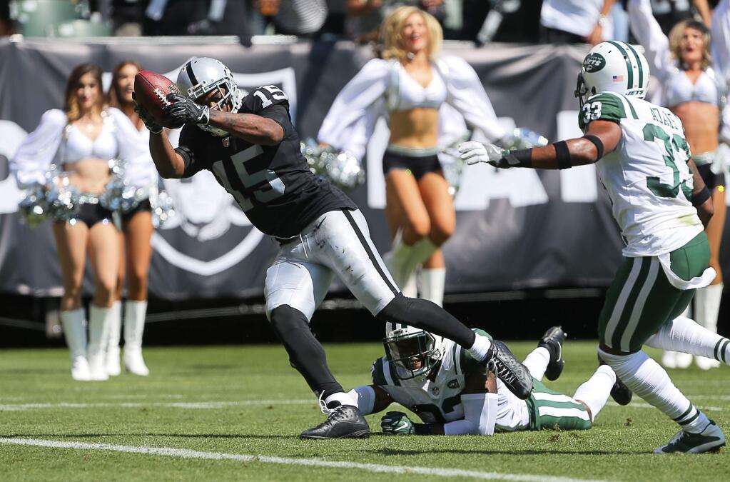 Oakland Raiders wide receiver Michael Crabtree scores a touchdown on a pass from quarterback Derek Carr against the New York Jets in Oakland on Sunday, Sept. 17, 2017. (Christopher Chung/ The Press Democrat)