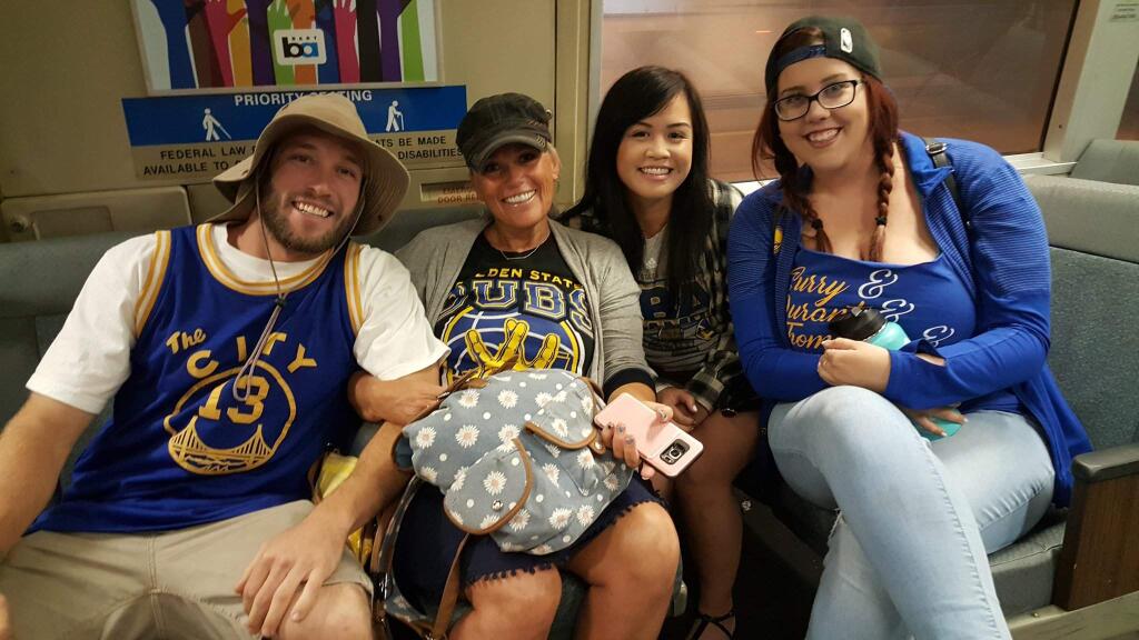 A group of basketball fans from Petaluma say they didn't mind waking up at 3 a.m. to get to the Warriors parade in Oakland, Thursday, June 15, 2017. (DEREK MOORE/ PD)
