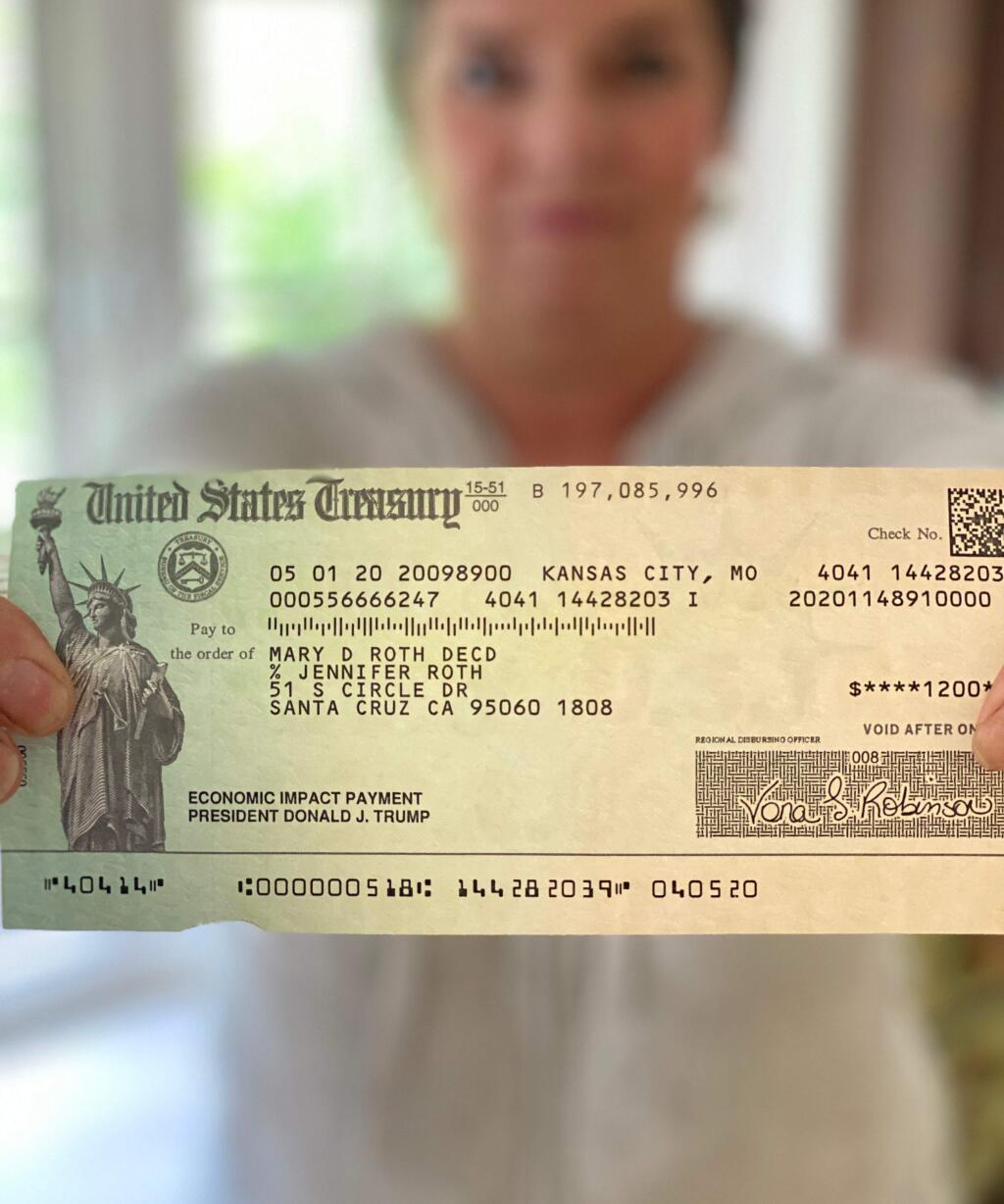 Reporter Kate Williams' sister displays the $1,200 stimulus check sent to their mother, who died in 2018. Behind her name is the abreviation 'decd,' indicating that the IRS had recorded her death.