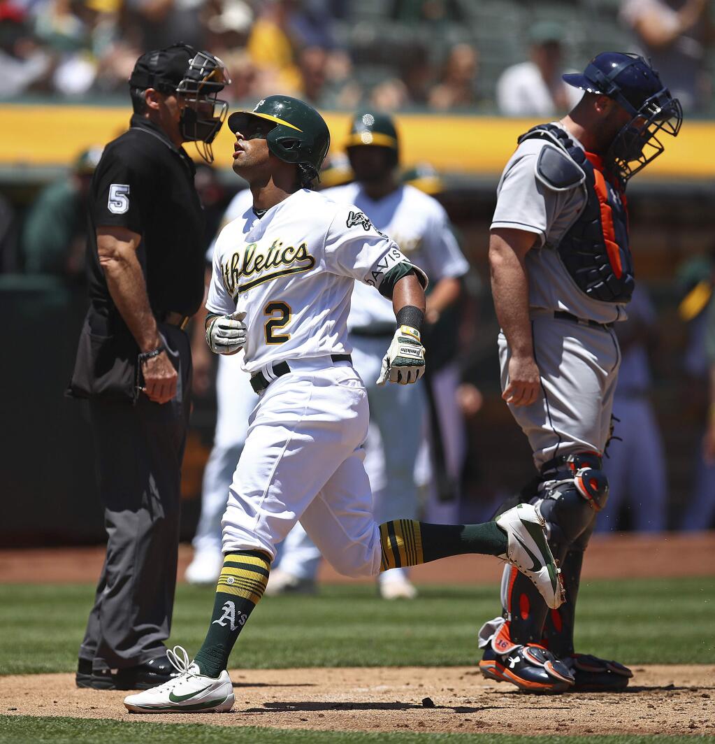 The Oakland Athletics' Khris Davis passes home plate and Houston Astros catcher Brian McCann, right, after hitting a home run off Justin Verlander in the second inning Thursday, June 14, 2018, in Oakland. (AP Photo/Ben Margot)