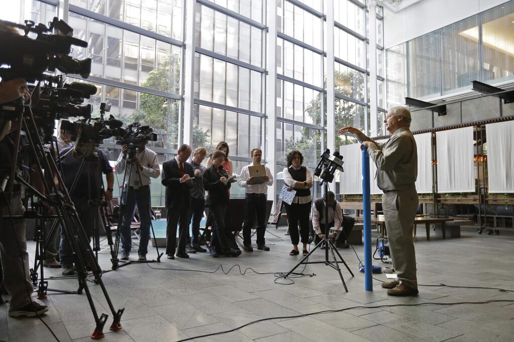 In this photo taken Monday, Sept. 26, 2016, soils engineer Patrick Shires talks with reporters at the Millennium Tower in San Francisco. The 58-story building has gained notoriety in recent weeks as the 'leaning tower of San Francisco.' It's not just leaning. It's sinking, too. And engineers hired to assess the problem say it shows no immediate sign of stopping. The sleek, mirrored high-rise that opened in 2009 as a haven for the city's well-heeled has sunk 16 inches and is leaning at least 2 inches toward other skyscrapers in the crowded downtown financial district. (AP Photo/Eric Risberg)