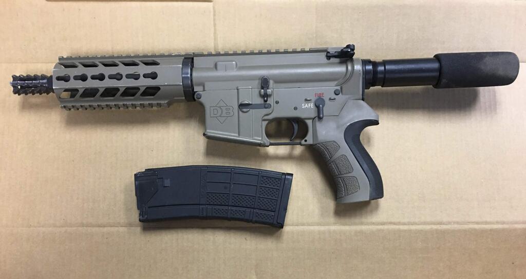 This Oct. 23, 2016, photo provided by the Madera Police Department shows a gun that was found near a patrol car that was shot at in Madera, Calif. Central California police are looking for the gunman who fired more than a dozen rounds at an officer and a civilian who was on a ride-along. The incident occurred early Sunday morning as the Madera officer tried to stop the vehicle and a pursuit ensued. (Madera Police Department via AP)