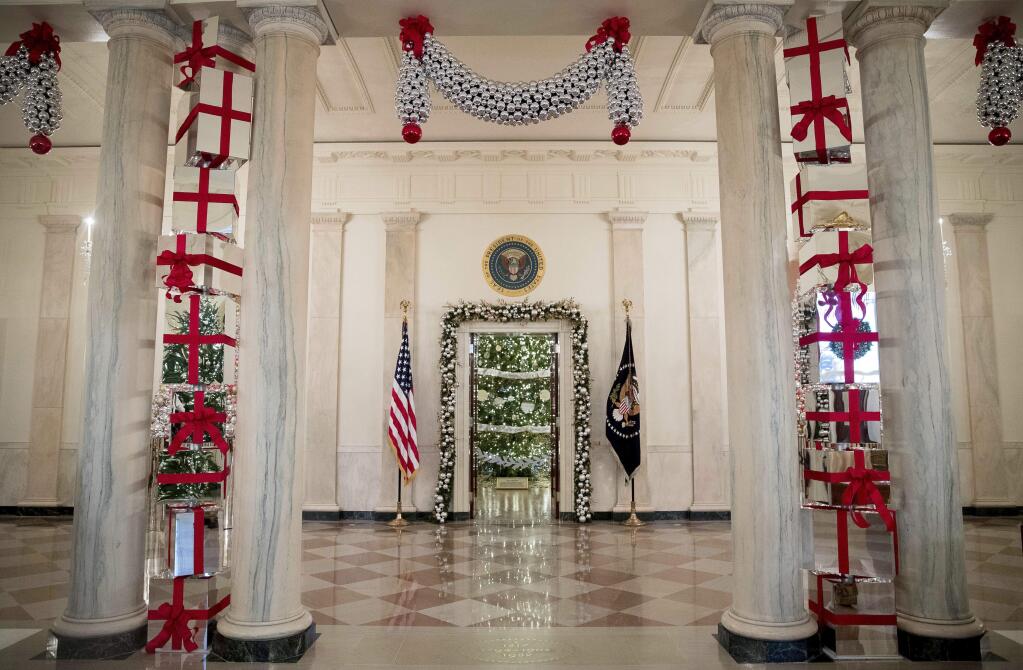 This year's White House Christmas Tree is seen inside the Blue Room from the Cross Hall of the White House during a preview of the 2015 holiday decor at the White House, Tuesday, Nov. 29, 2016, in Washington. (AP Photo/Andrew Harnik)