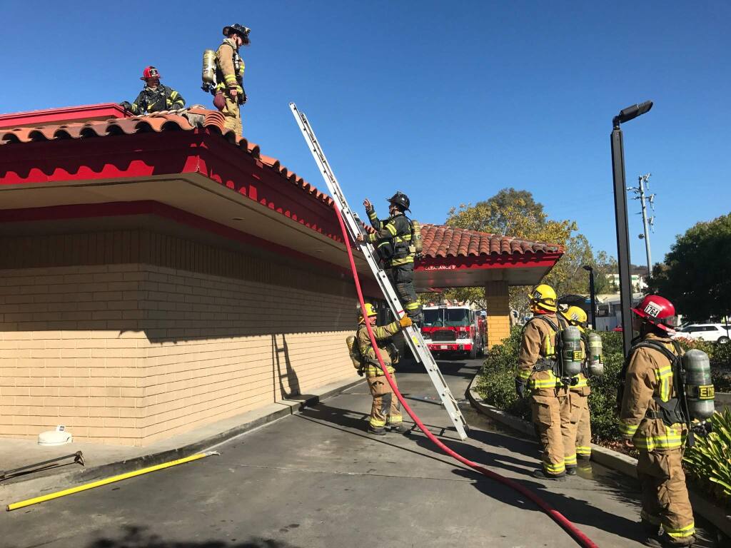 Firefighters respond to a grease fire at a Carl's Jr. restaurant in Santa Rosa. The fire started while the restaurant was making 165 Super Star double hamburgers for first responders. Thursday, Oct. 27, 2017. (Beth Shlanker / Press Democrat)