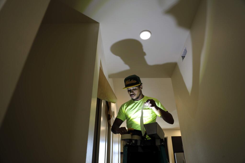 Alexander Rominger of Katerra Construction does drywall finishing in a new unit of the Annadel apartment complex on Monday, April 30, 2018 in Santa Rosa, California . (BETH SCHLANKER/The Press Democrat)