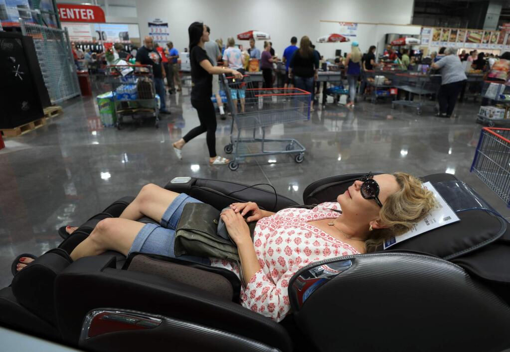 Fort Bragg resident Mary King lounges in a recliner during the grand opening of the Ukiah Costco, Thursday, July 19, 2018. King cut an hour of drive time by not having to travel to shop at the Santa Rosa Costco. (Kent Porter / The Press Democrat) 2018