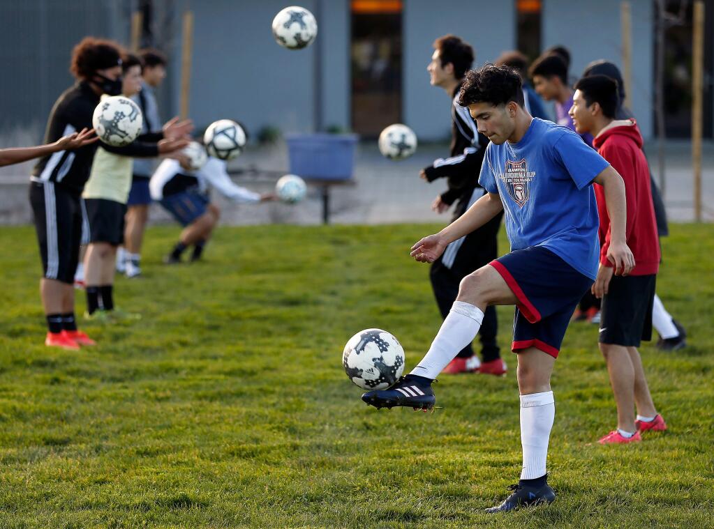Roseland University Prep's Jose Pineda and the rest of the team conduct warmup drills during boys varsity soccer practice at Roseland University Prep high school in Santa Rosa on Wednesday, January 30, 2019. (Alvin Jornada / The Press Democrat)
