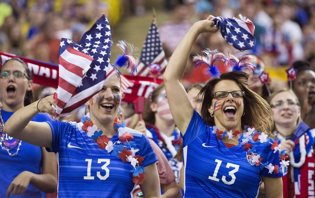 FILE - In this June 30, 2015, file photo, U.S. fans cheer on the team before the team's semifinal against Germany in the Women's World Cup soccer tournament in Montreal, Canada. With many matches in prime time, this Women's World Cup has set all sorts of TV viewership records in the U.S. Sunday's final could break some more. (Graham Hughes/The Canadian Press via AP, File)