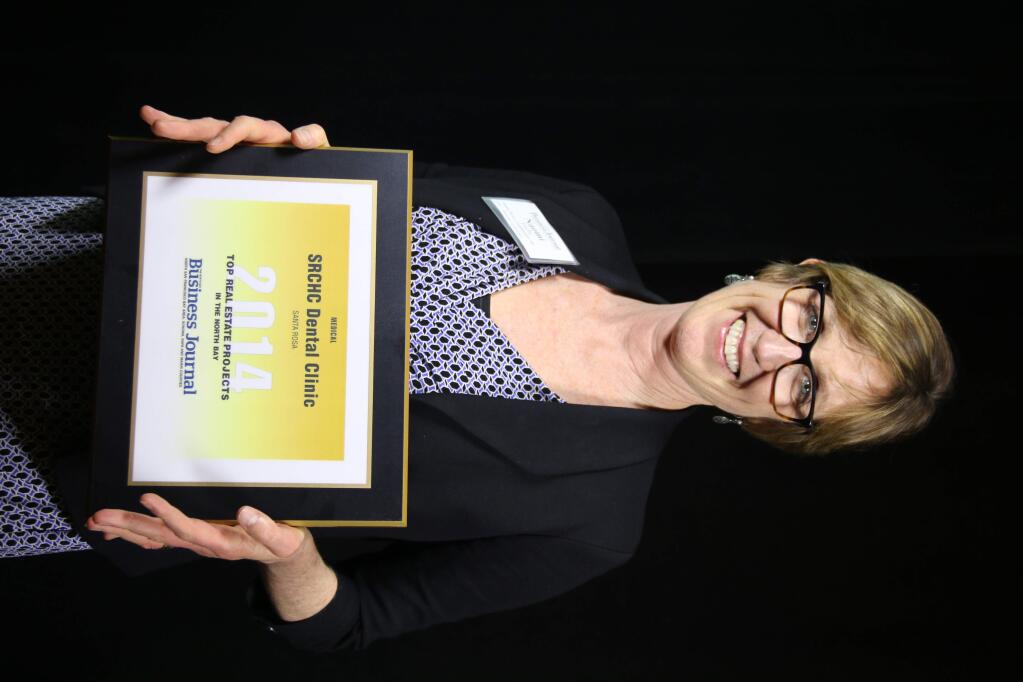 Naomi Fuchs, CEO of Santa Rosa Community Health Centers, accepts an award for the centers' dental clinic project at the Business Journal's Top Real Estate Projects in the North Bay at Doubletree Hotel in Rohnert Park on Dec. 18, 2014. (Jeff Quackenbush, The Business Journal)