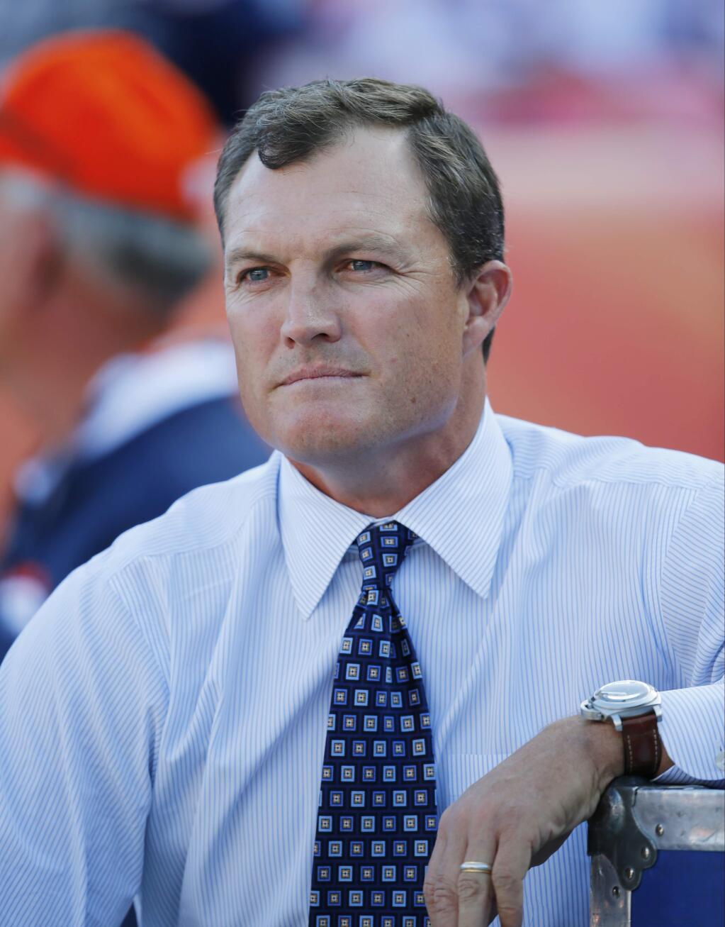 Former NFL football safety John Lynch, now a broadcast analyst for FOX sports, sits on the sideline before a preseason NFL football game between the Denver Broncos and the San Francisco 49ers, Saturday, Aug. 20, 2016, in Denver. (AP Photo/Jack Dempsey)