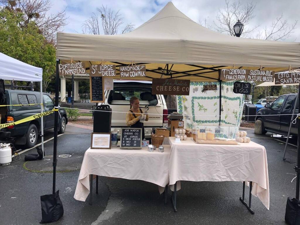 Many local farmers markets are still open, and sellers like Joe Matos Cheese Co. at the Sebastopol Farmers Market are following measures, such as social distancing and pre-packaging food, to curb the spread of coronavirus. Photo by Michele Anna Jordan