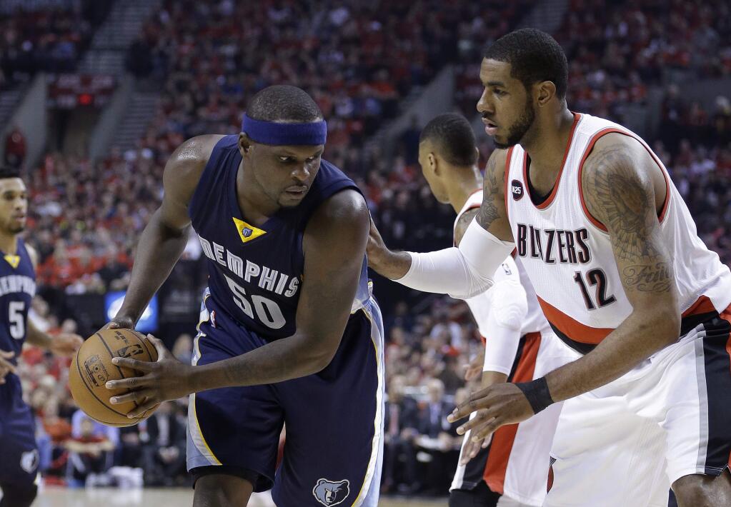 Memphis Grizzlies forward Zach Randolph, left, looks to maneuver against Portland Trail Blazers forward LaMarcus Aldridge during the first half of Game 4 in a first-round NBA basketball playoff series Monday, April 27, 2015, in Portland, Ore. (AP Photo/Don Ryan)