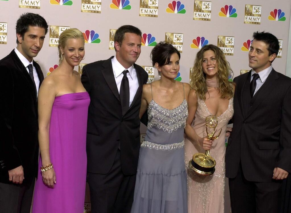 FILE - In this Sept. 22, 2002 file photo, the stars of 'Friends,' from left, David Schwimmer, Lisa Kudrow, Matthew Perry, Courteney Cox Arquette, Jennifer Aniston and Matt LeBlanc pose after the show won outstanding comedy series at the 54th Annual Primetime Emmy Awards, at the Shrine Auditorium in Los Angeles. If you're a “Friends” superfan, there are lots of ways to celebrate the show's 25th anniversary on Sept. 22, 2019. Warner Bros. has partnered with a range of companies to celebrate the quarter-century mark. (AP Photo/Reed Saxon, file)