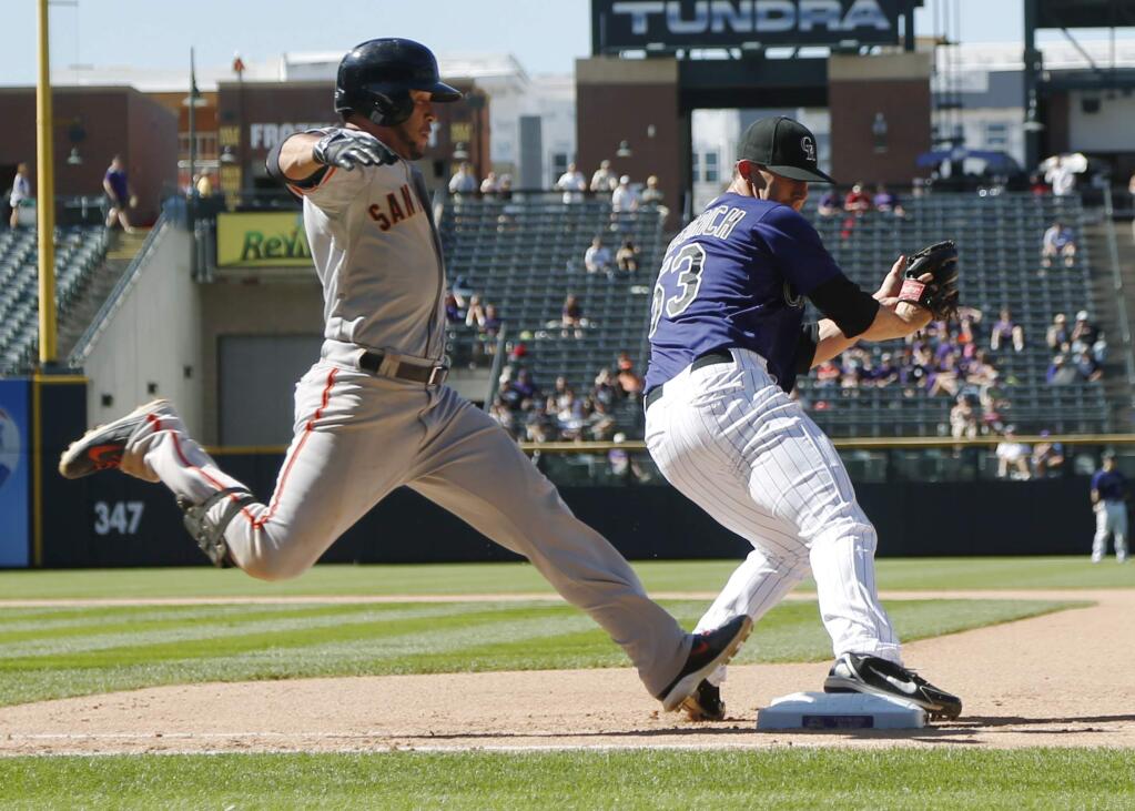 San Francisco Giants' Gregor Blanco, left, is out at first base as Colorado Rockies relief pitcher Christian Friedrich fields throw from second baseman DJ LeMahieu during the seventh inning of the Rockies' 9-2 victory in a baseball game in Denver on Wednesday, Sept. 3, 2014. (AP Photo/David Zalubowski)