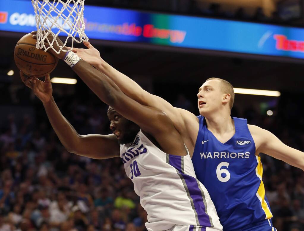 Sacramento Kings forward Caleb Swanigan, left, grabs a rebound against Golden State Warriors forward Alen Smailagic during the first half of an NBA summer league game in Sacramento, Monday, July 1, 2019. The Kings won 81-77. (AP Photo/Rich Pedroncelli)