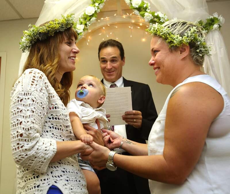 Sonoma County Clerk Bill Rousseau presided July 1, 2013 over the marriage of Amy Evans-Reber, left, holding son Cash and Emily Evans-Reber after the Supreme Court ruled California's Proposition 8. (John Burgess/The Press Democrat)