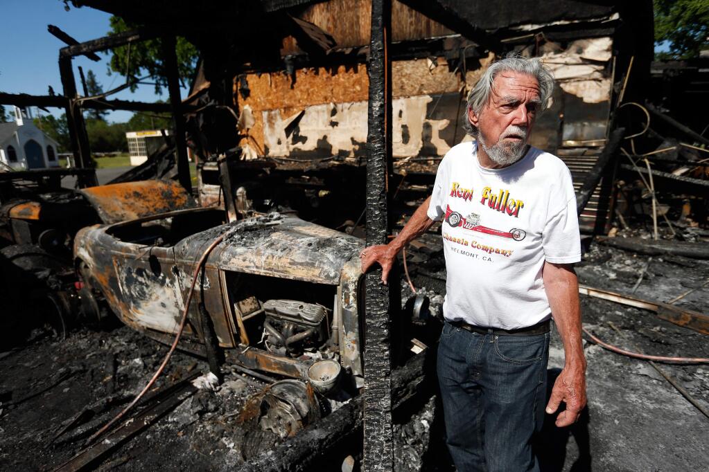 Fred Stoke surveys the aftermath of a fire at his garage that destroyed 14 of his classic cars, including the 1932 Ford Highboy Roadster, left, at Stoke Ranch in Santa Rosa, California, on Saturday, April 30, 2016. (Alvin Jornada / The Press Democrat)