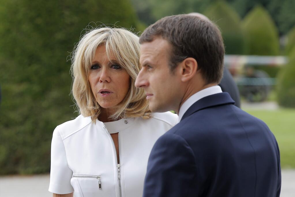 French President Emmanuel Macron and his wife Brigitte wait at the Invalides museum in Paris Thursday, July 13, 2017. President Donald Trump and French President Emmanuel Macron planned to meet Thursday in Paris to focus on issue where they can take U.S.-French relations forward, security and defense issues chief among them. (AP Photo/Michel Euler)