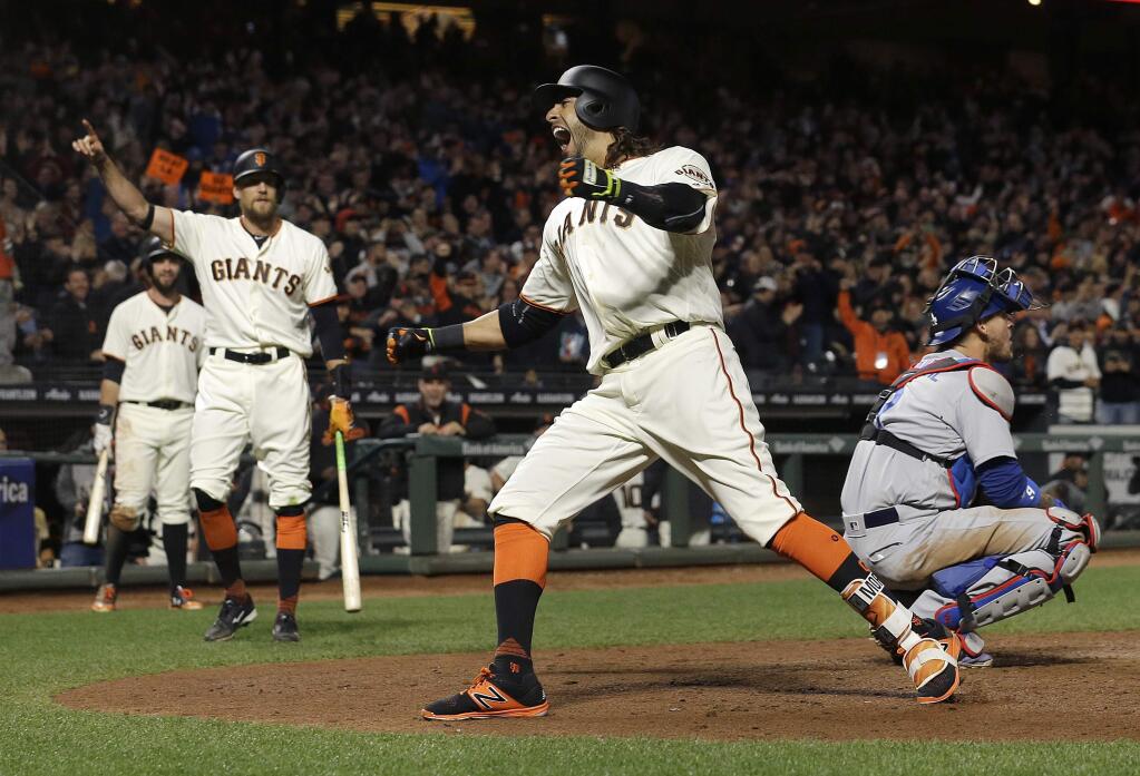 The San Francisco Giants' Michael Morse, center, reacts as he crosses home plate after hitting a solo home run in front of Los Angeles Dodgers catcher Yasmani Grandal, right, during the eighth inning in San Francisco, Wednesday, April 26, 2017. (AP Photo/Jeff Chiu)