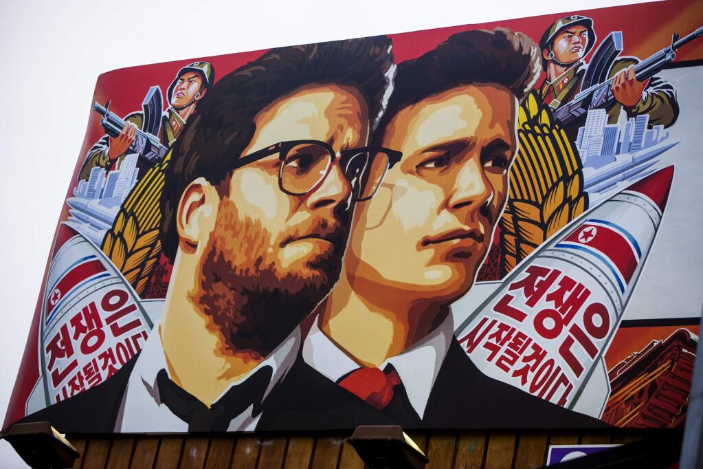A banner for 'The Interview'is posted outside Arclight Cinemas, Wednesday, Dec. 17, 2014, in the Hollywood section of Los Angeles. (AP Photo/Damian Dovarganes)