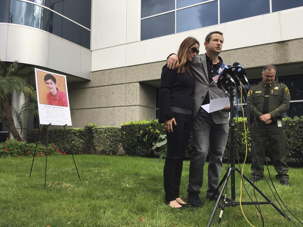 Gideon and Jeanne Bernstein, parents of missing teen Blaze, pictured left, are joined by Orange County Sheriff's Lt. Brad Valentine, right, during a news conference in Lake Forest, Calif., Wednesday, Jan. 10, 2018, The body of the University of Pennsylvania student who went missing on Jan. 2, while home in Southern California on winter break has been found, and his death is being investigated as a homicide, authorities said on Wednesday. (AP Photo/Amy Taxin)