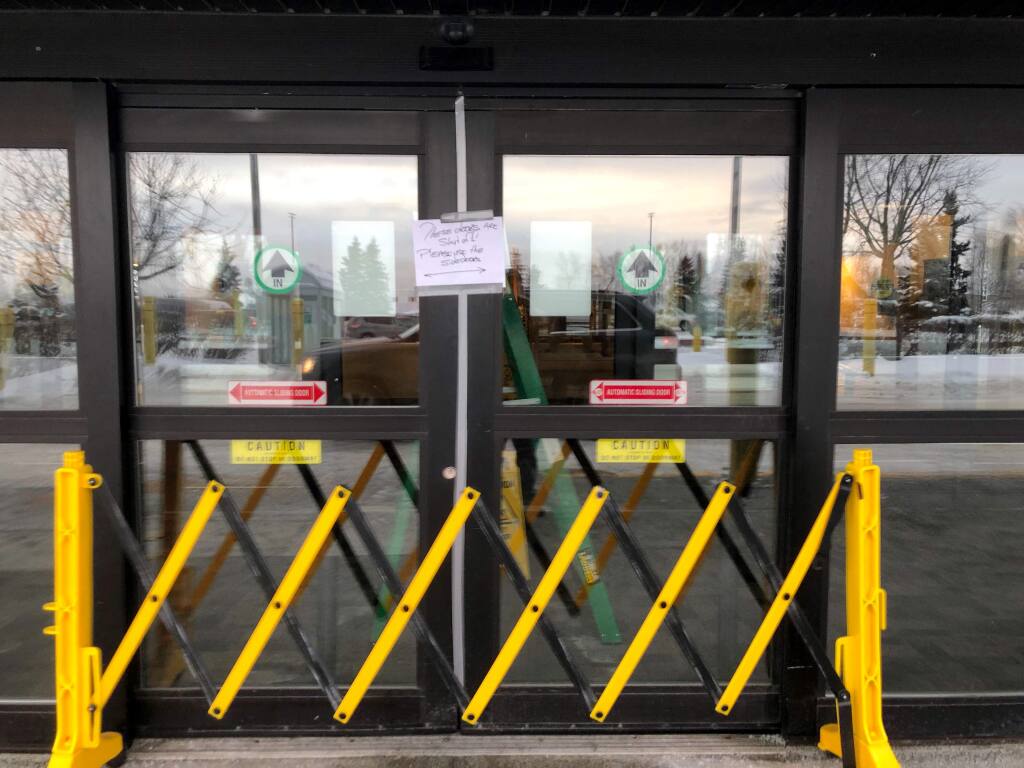 A closed entrance at the north terminal at Ted Stevens Anchorage International Airport in Anchorage, Alaska, where a flight plane carrying U.S. citizens being evacuated from Wuhan, China is expected later Tuesday, is seen Tuesday, Jan. 28, 2020. (AP Photo/Mark Thiessen)