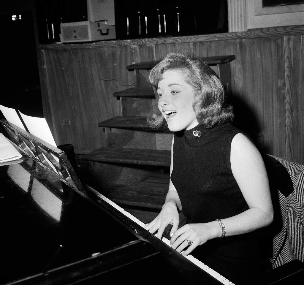 FILE - In this Jan. 5, 1966, file photo, singer Lesley Gore rehearses at a piano, in New York. Singer-songwriter Gore, who topped the charts in 1963 with her epic song of teenage angst, 'It's My Party,' and followed it up with the hits 'Judy's Turn to Cry,' and 'You Don't Own Me,' died of cancer, Monday, Feb. 16, 2015. She was 68. (AP Photo/Dan Grossi, File)
