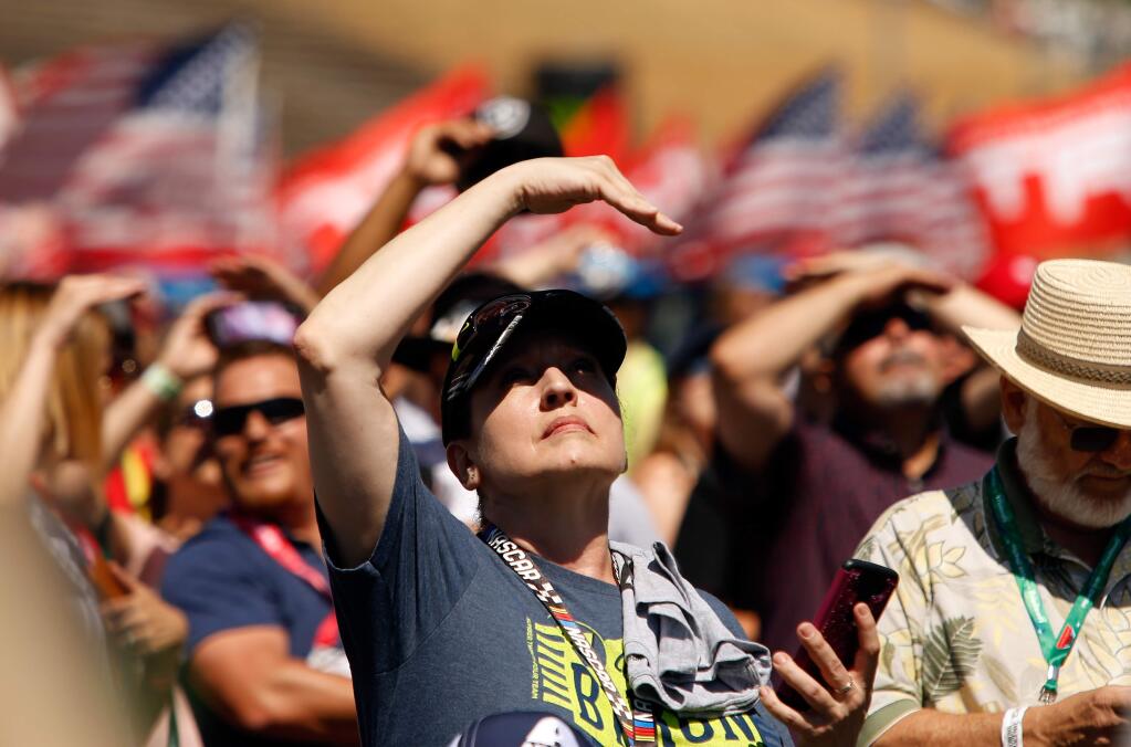 Race fans watch the Patriots Jet Team perform during the pre-race show before the NASCAR Toyota/Save Mart 350 race at Sonoma Raceway on Sunday, June 24, 2018. (Alvin Jornada / The Press Democrat)