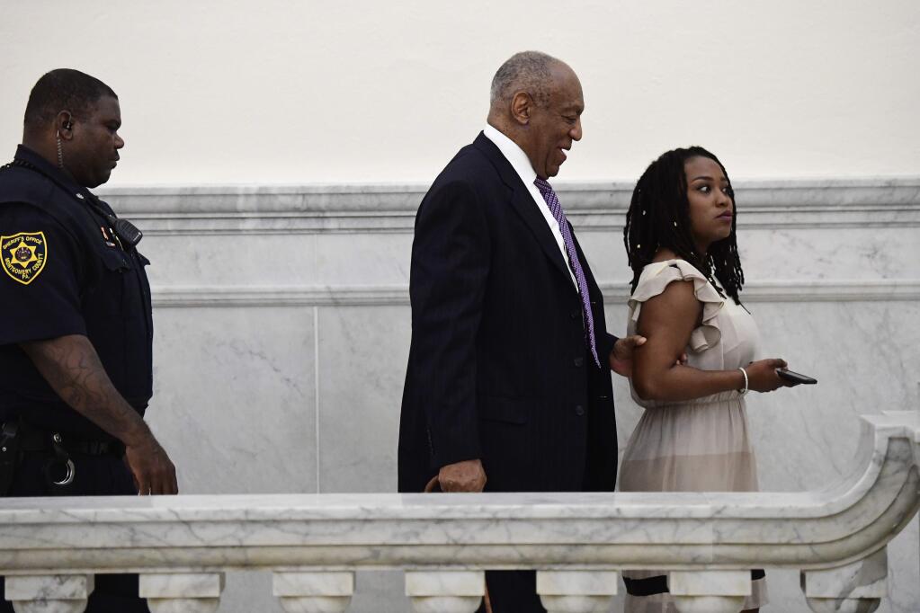 Bill Cosby, center, walks with publicist Ebonee Benson during a break in his sexual assault trial at the Montgomery County Courthouse, Wednesday, April 18, 2018, in Norristown, Pa. (AP Photo/Corey Perrine, Pool)