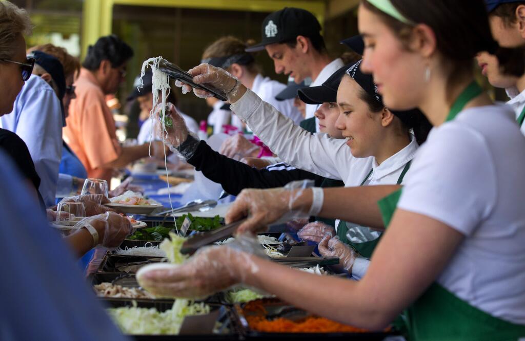 Culinary teens from the Ceres Project teamed with chef John Ash for a create-your-own spring roll bar at the North Coast Wine and Food Festival at Sonoma Mountain Village in Rohnert Park on Saturday. (photo by John Burgess/The Press Democrat)