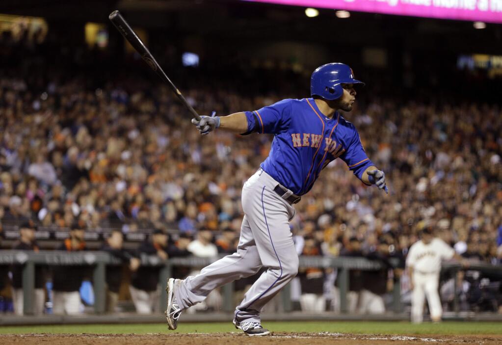 New York Mets catcher Johnny Monell swings for a two-run double off San Francisco Giants' Santiago Casilla in the ninth inning of a game Monday, July 6, 2015, in San Francisco. (AP Photo/Ben Margot)