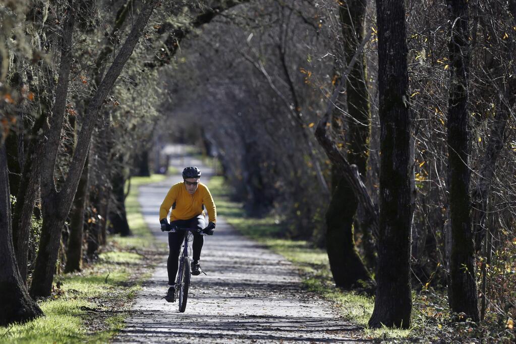 BETH SCHLANKER / The Press DemocratJon Peterson bikes Monday along the West Country Regional Trail in Forestville.
